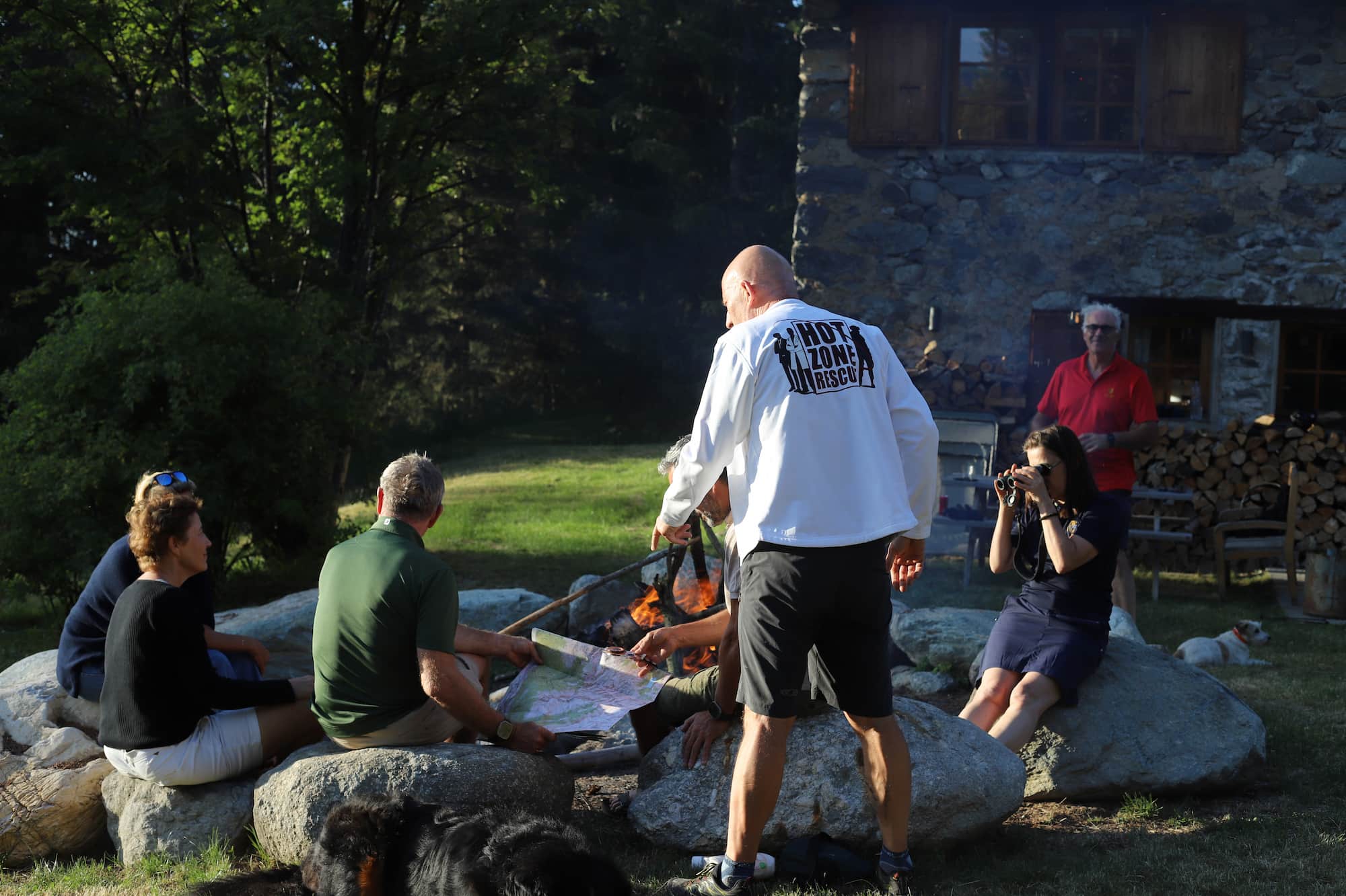 Cercle de participants en feu de camp en montagne – team-building Hot Zone Rescue